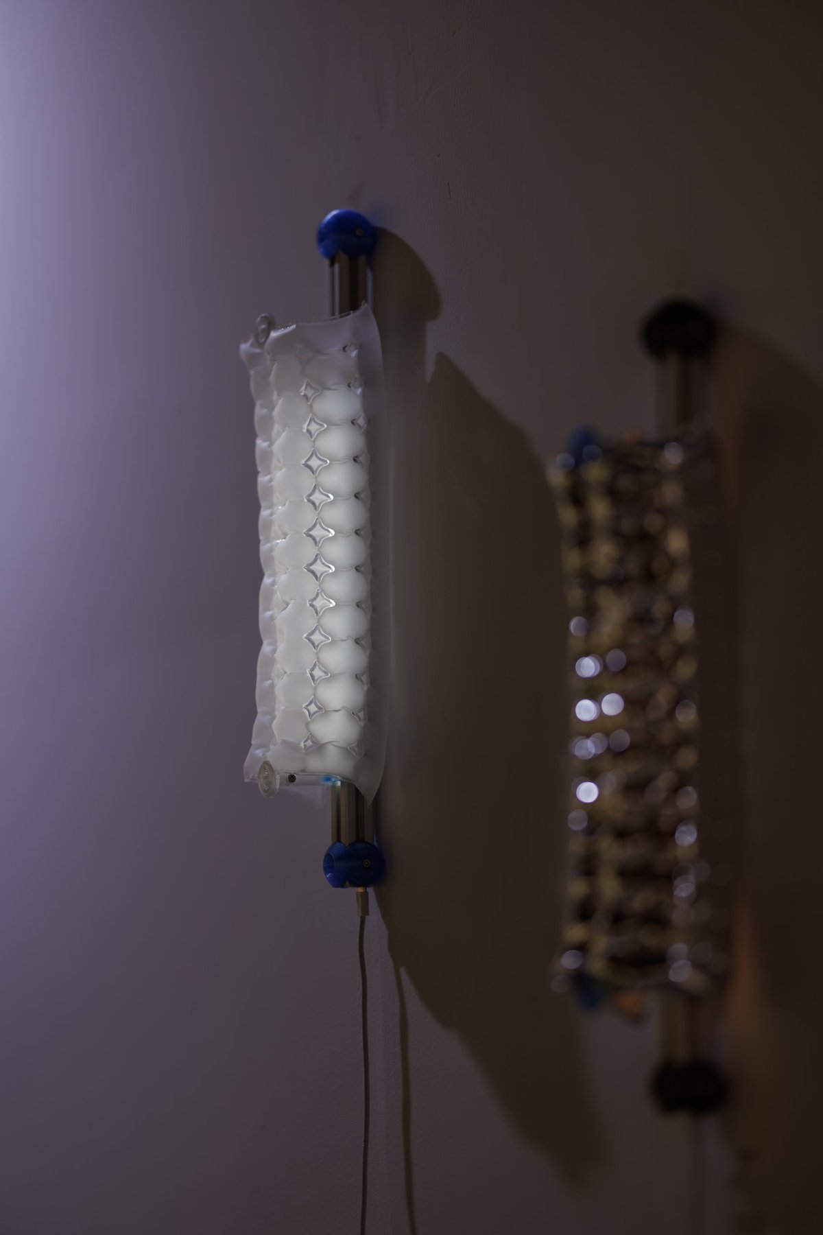 Air Forming Lamp mounted on a wall, side view