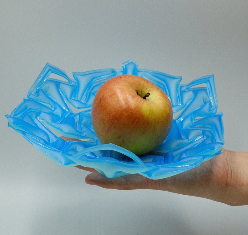 MORPHILITY – inflatable utensil holding an apple